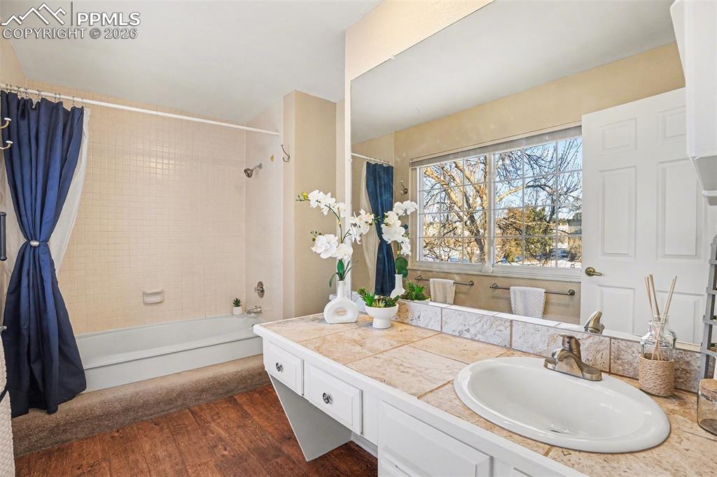 Spacious primary bedroom with a full adjoining bath, abundant natural light, and plenty of room to relax.