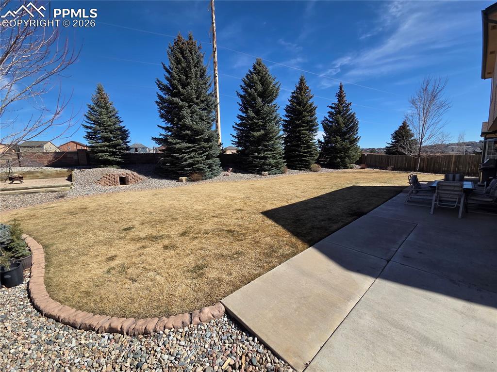 Fenced backyard with a patio area
