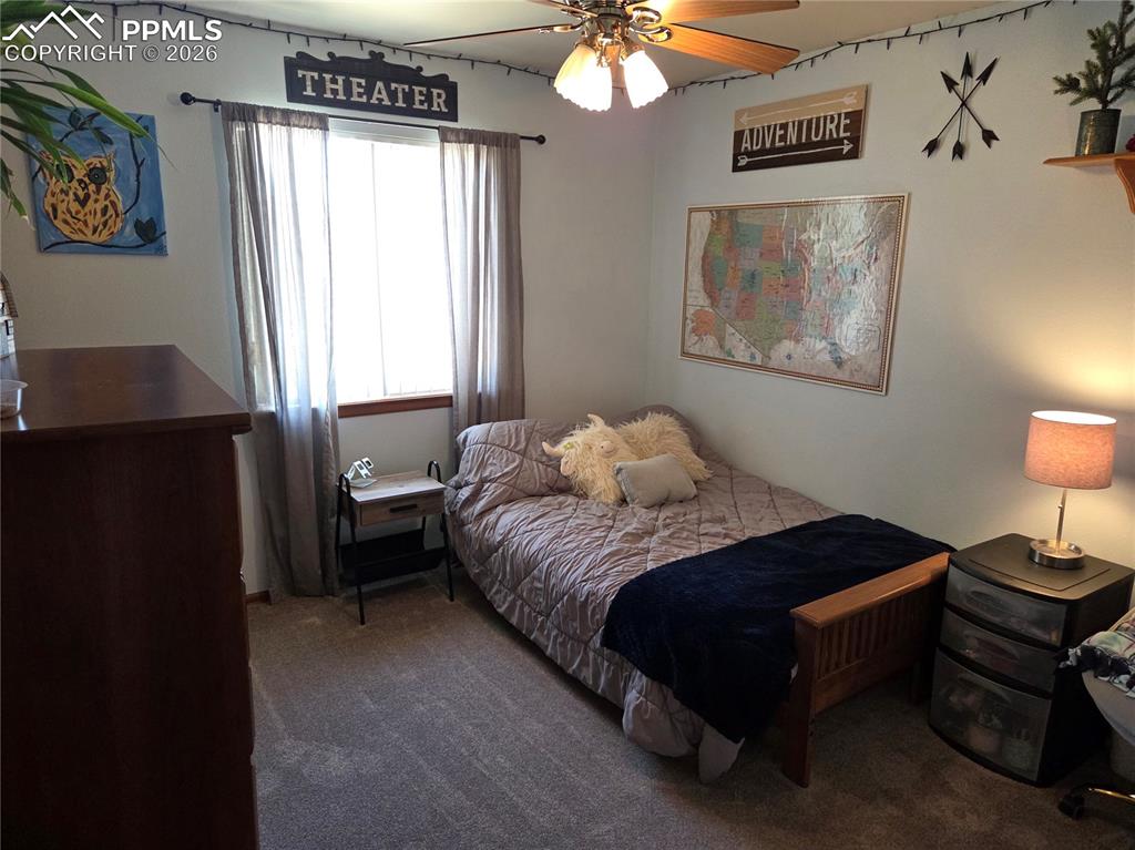 Bedroom featuring dark carpet