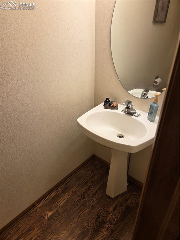 Bathroom with dark wood finished floors and baseboards