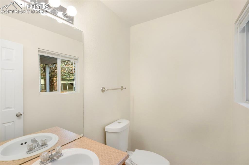 Half bath with vanity and toilet