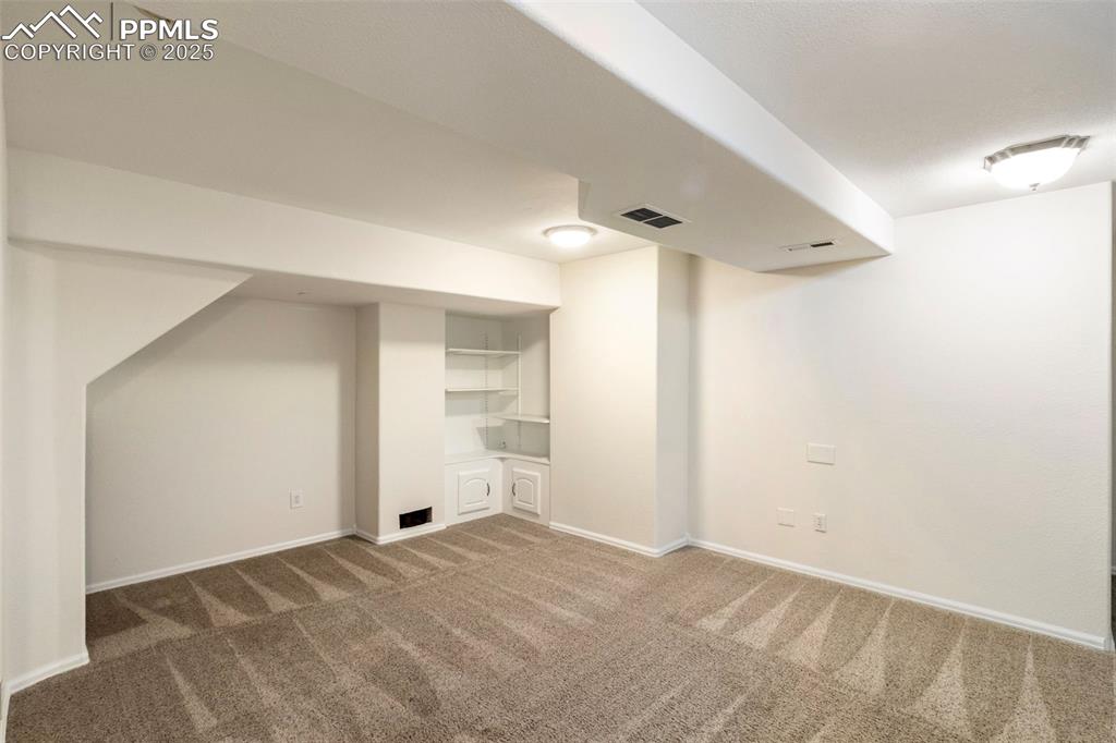 Finished below grade area featuring carpet and baseboards