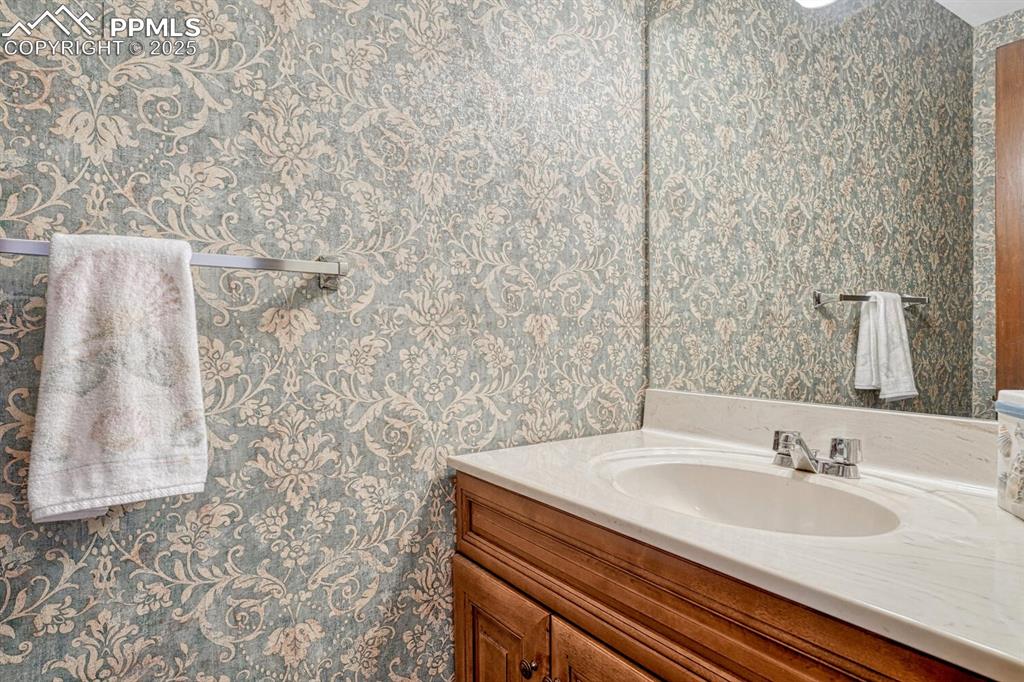 A half bathroom on the main floor offers a touch of elegance with its sleek vanity.