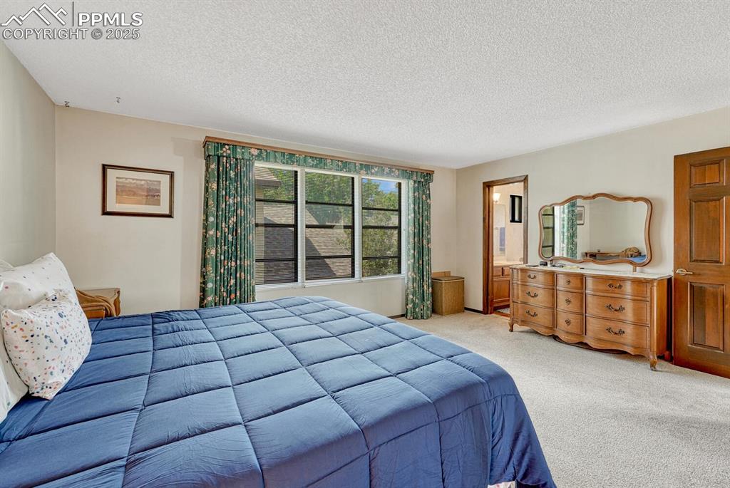 Carpeted bedroom featuring a textured ceiling