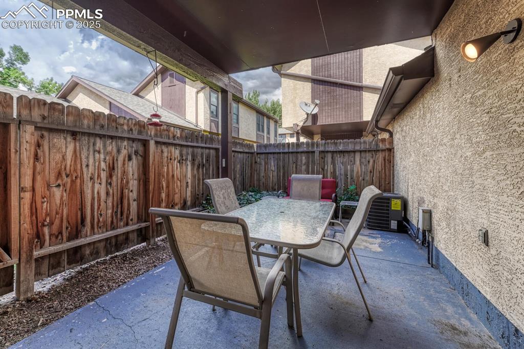 This securely fenced backyard presents a designated patio area perfect for entertaining, along with easy access to the garage.