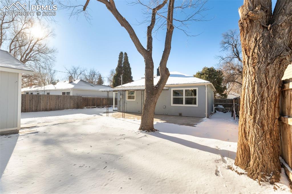 Large fully fenced back yard with covered patio.