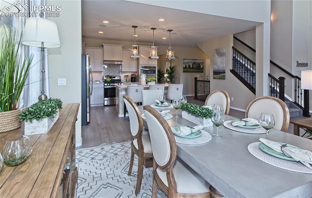 Dining area with stairway, recessed lighting, and wood finished floors