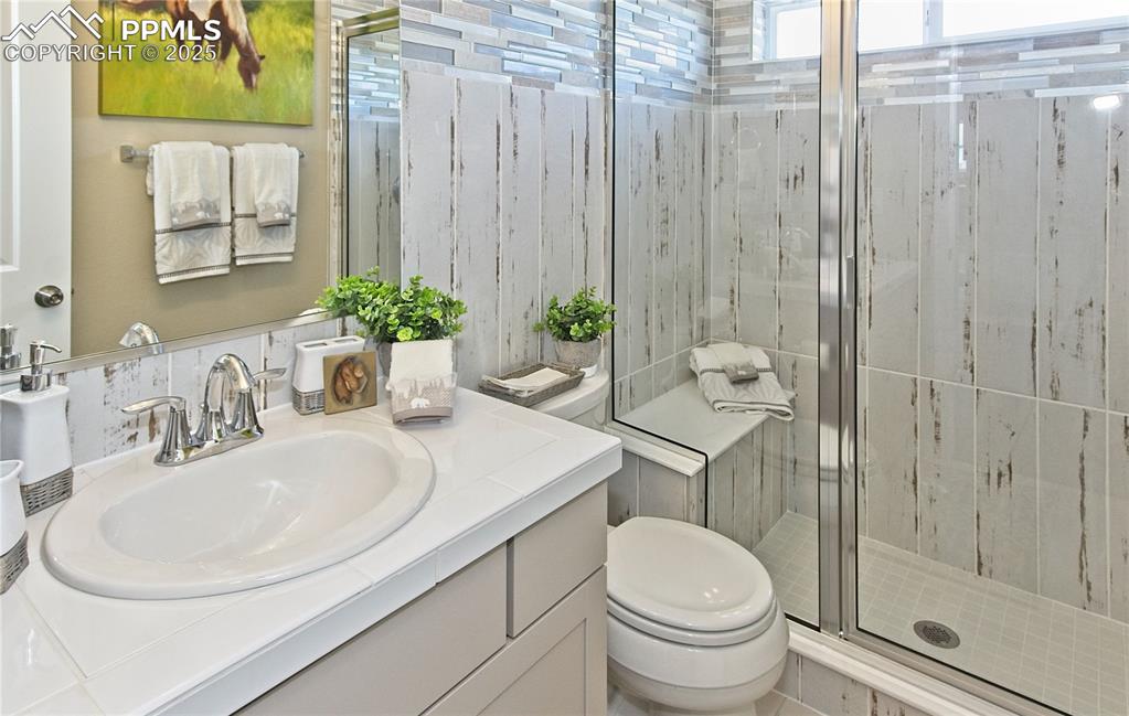 Full bathroom with a stall shower and vanity