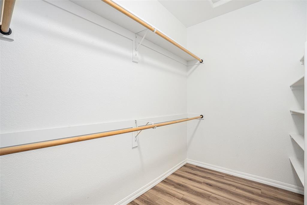 Walk in closet featuring wood finished floors