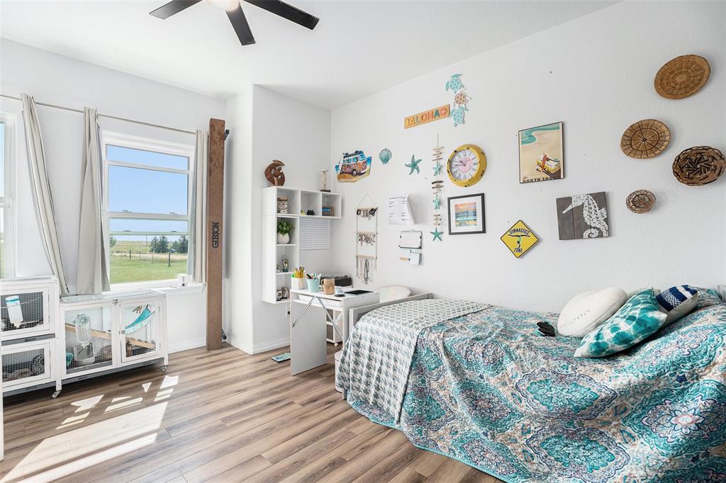 Bedroom featuring wood finished floors and ceiling fan