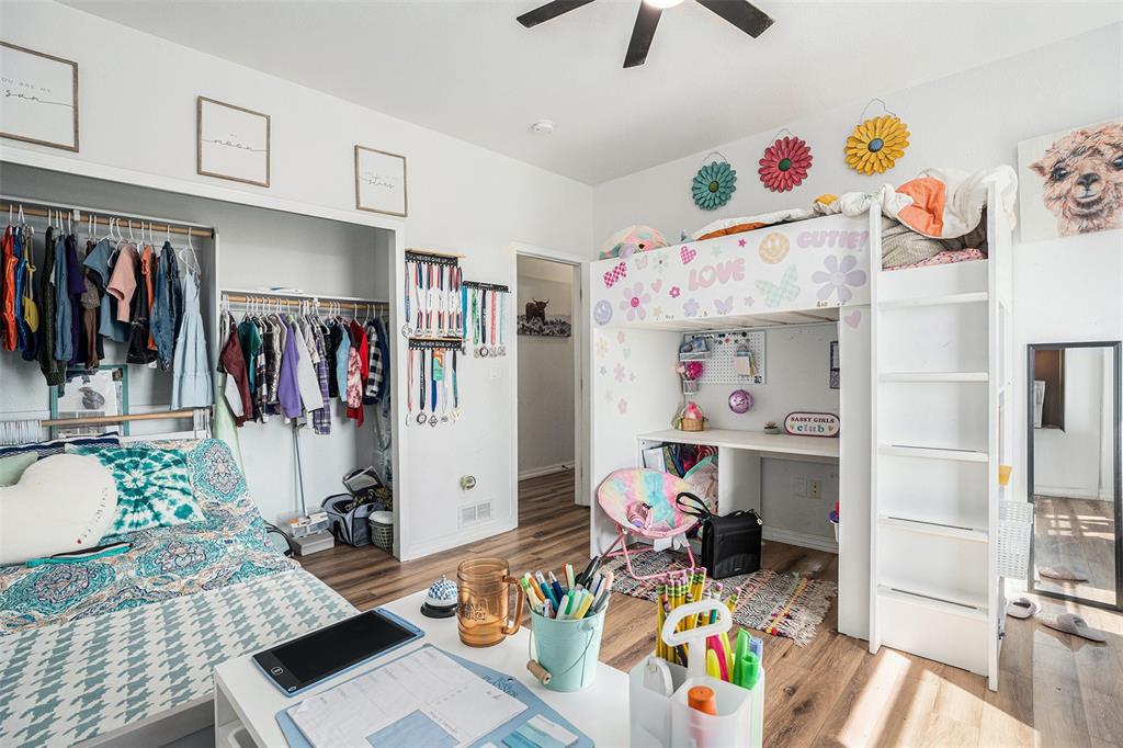 Bedroom featuring light wood-style flooring, a closet, and a ceiling fan