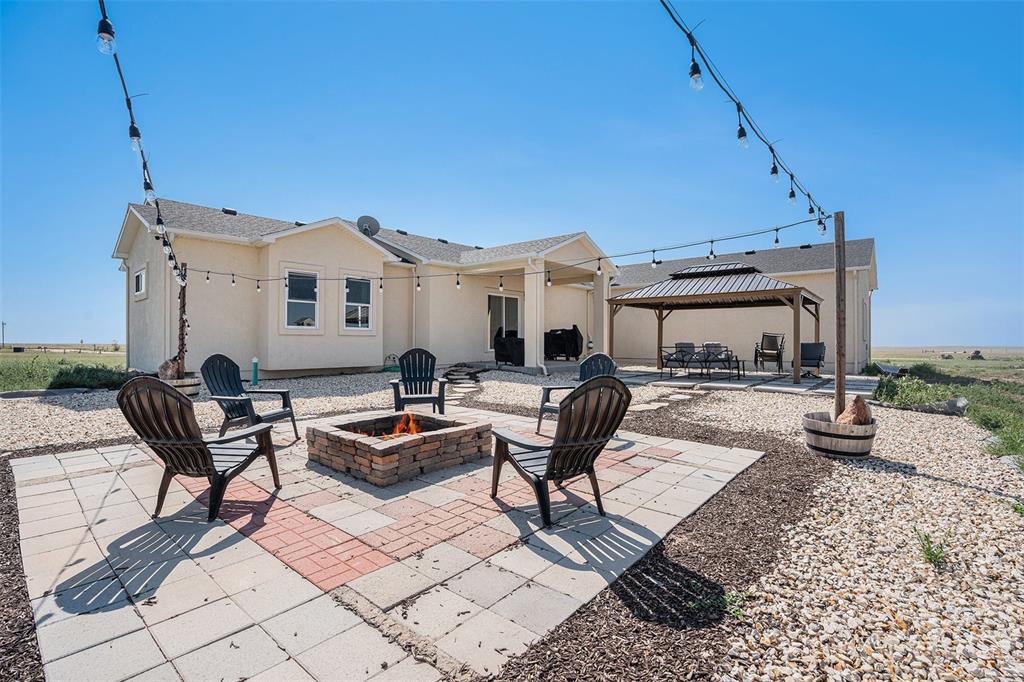 View of patio / terrace with an outdoor fire pit and a gazebo
