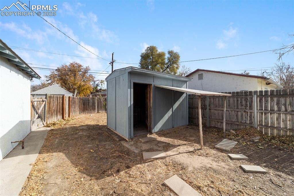 View of shed featuring a fenced backyard