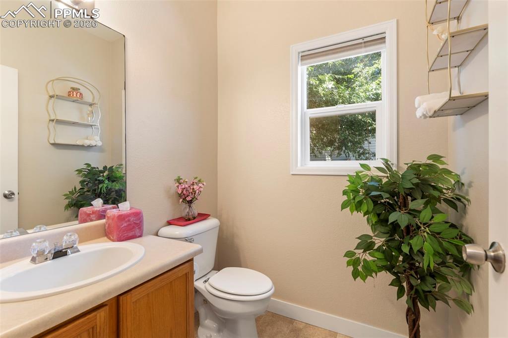 Half bathroom with vanity and toilet