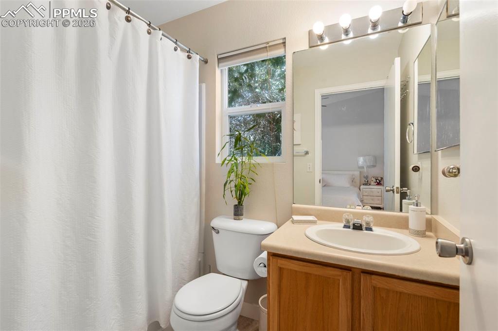 Bathroom featuring curtained shower and vanity