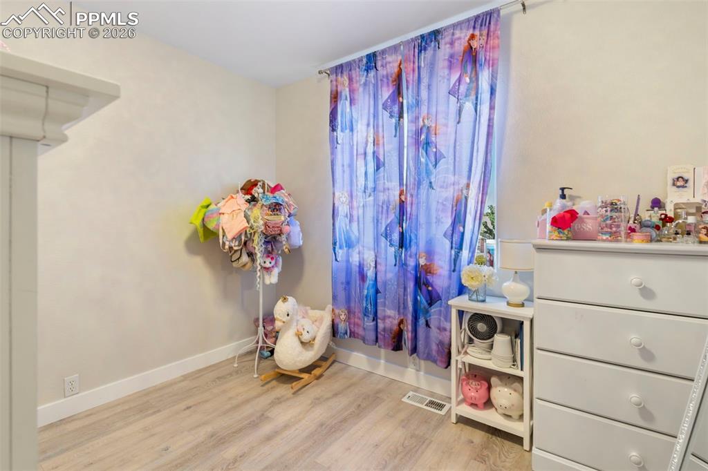Rec room featuring baseboards and light wood-style flooring