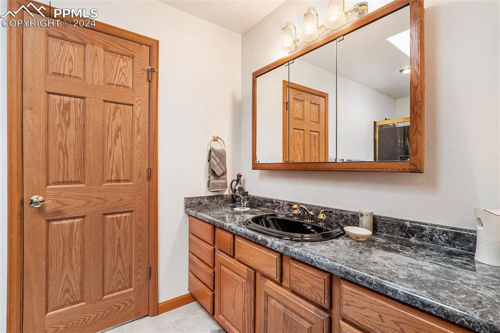 Jack and Jill Full Bathroom with tile floors and vanity