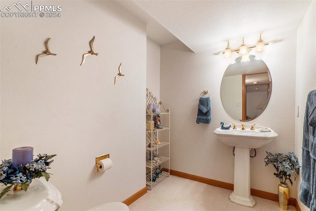 Basement 1/2 Bathroom with tile floors