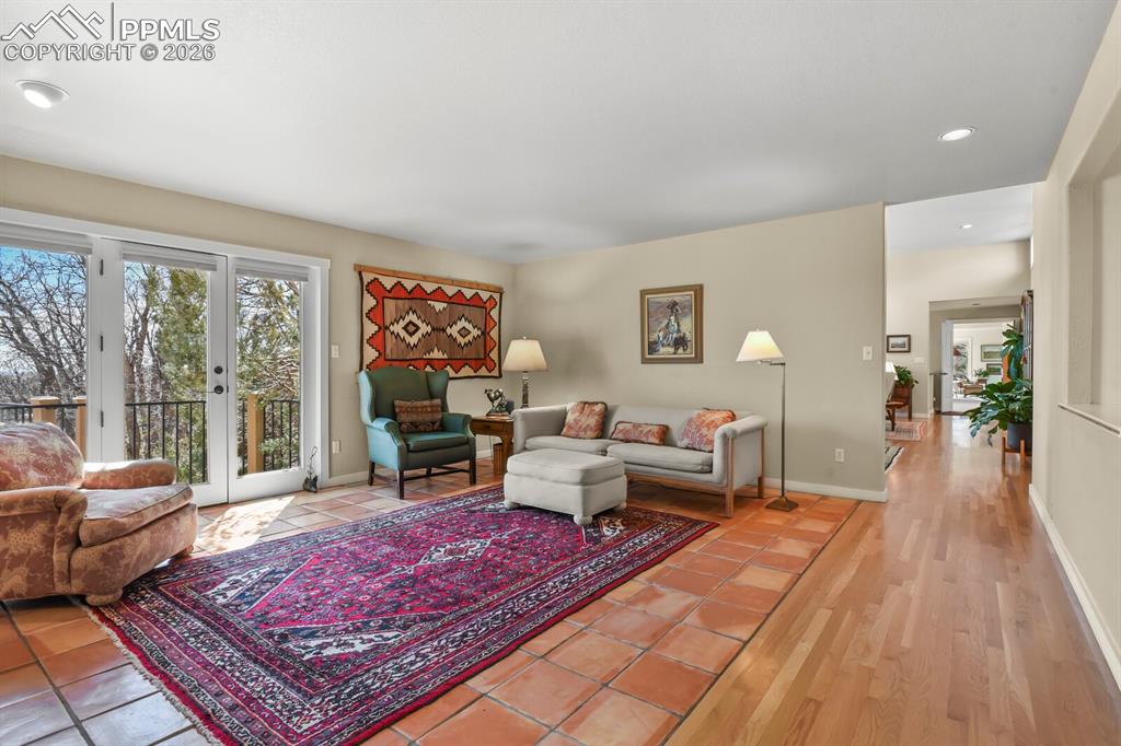 Family Room with beautiful, practical Saltillo tile, and french doors to the completely replaced deck with Trex/composite flooring and wrought iron railings.  Enjoy the views outside from the deck. A large area of the yard is fenced.