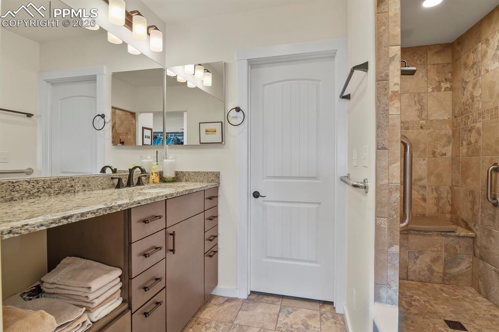 Fully remodeled Primary Bathroom Suite with double vanities each in their own space, separate toilet room and a large walk-in tiled shower.