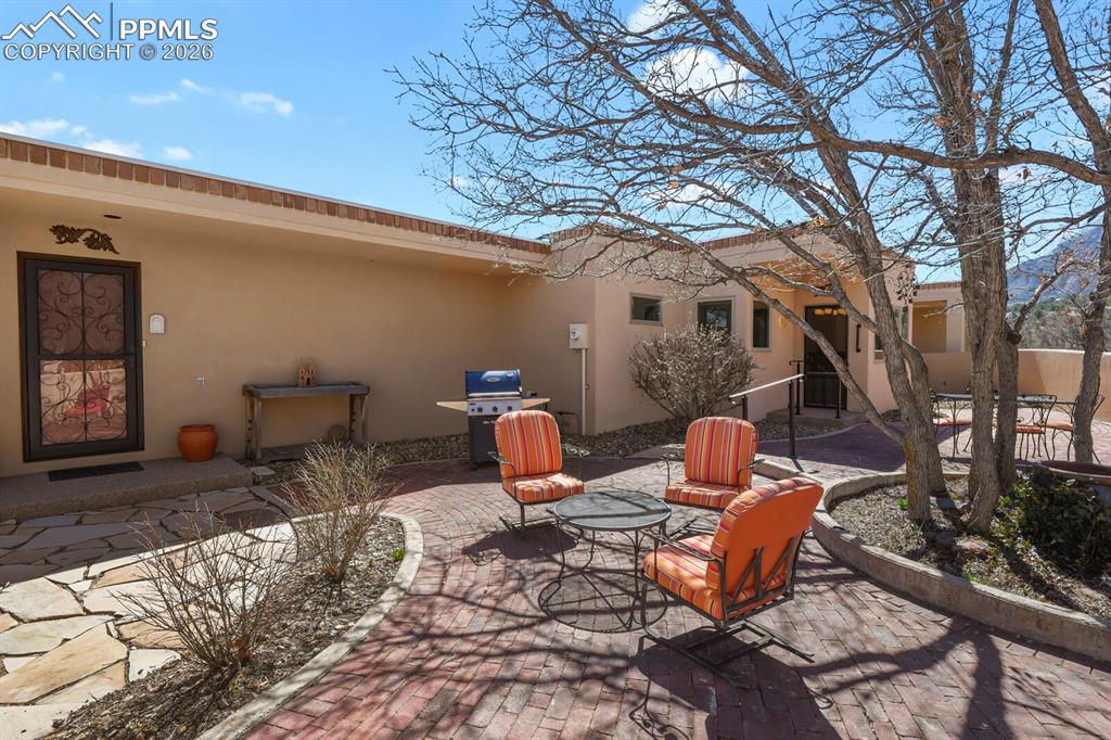 View of the walled patio and backdoor entrance into the home.  