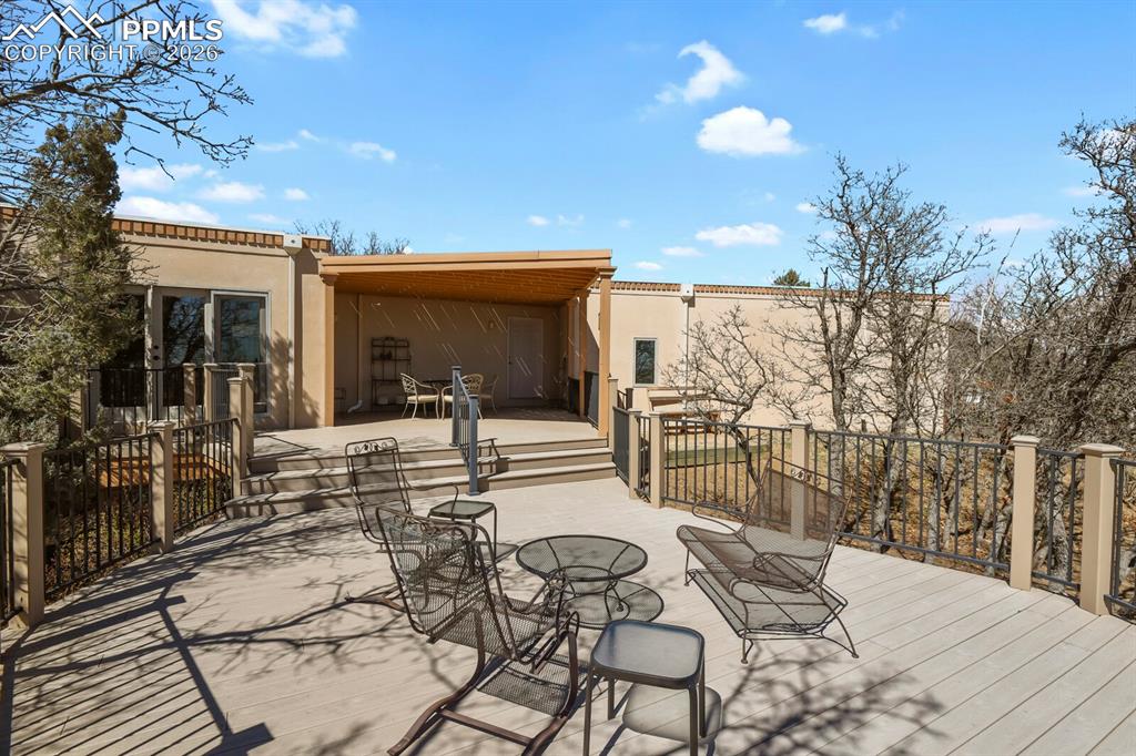 View looking to the home from the huge Trex Deck with Wrought Iron railings.  