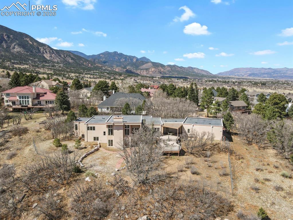 Aerial View of the back of the home, showing the deck and the almost an acre of property.