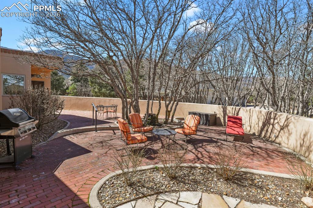 Fenced patio area, showing mountain views.
