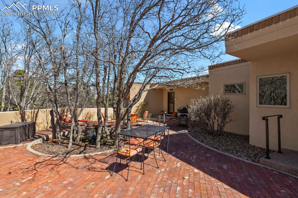 Walled paved and landscaped patio area.