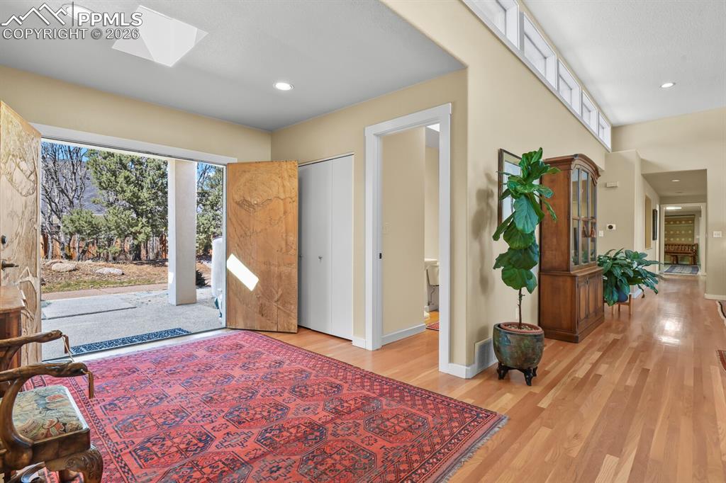 Covered porch area, double doors, enter into the foyer with hardwood floors and convenient powder room.  All doors/frames in the home are 7ft tall. 