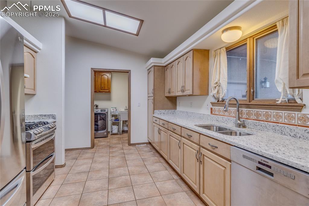 Kitchen with tile floors/new granite counter tops - straight ahead is the laundry room and door to the 3 car garage. 