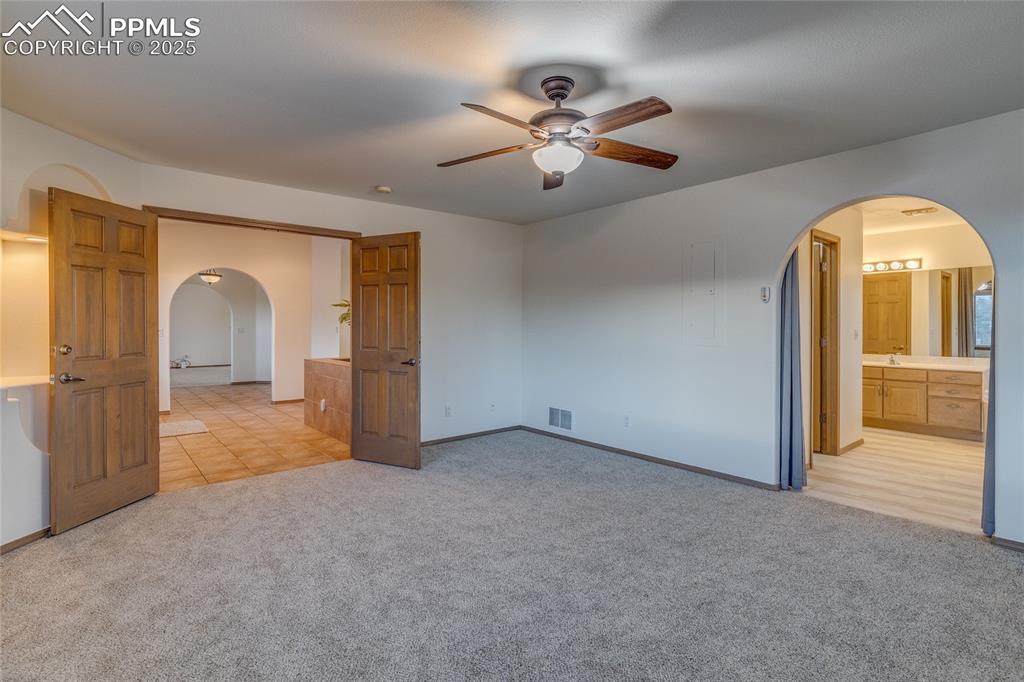 Primary bedroom with primary bathroom to the right. 