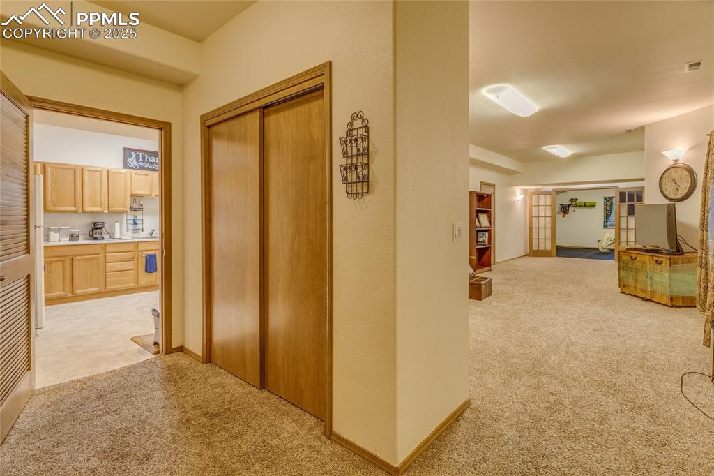 At bottom of stairs to basement - basement family room and work out room to the right, kitchenette to the left.