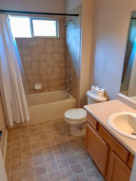 Bathroom featuring shower / bath combo and vanity