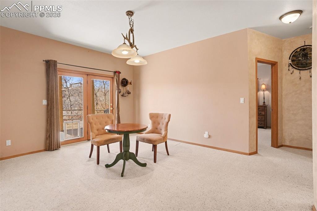 Dining room with light carpet and baseboards