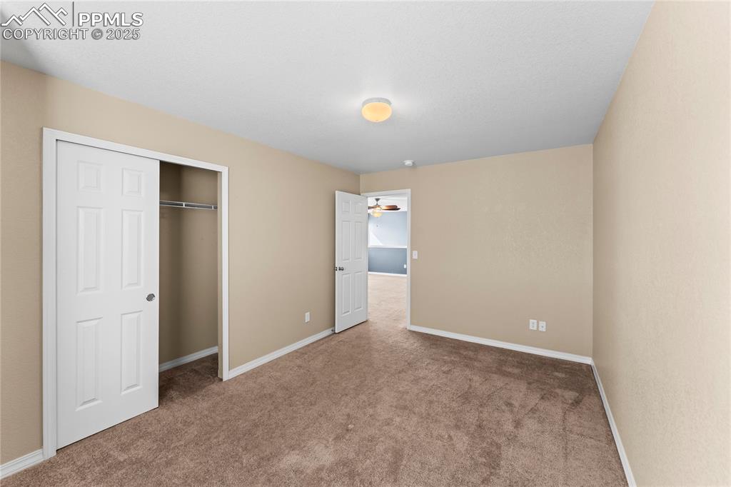 Unfurnished bedroom with carpet flooring and a closet