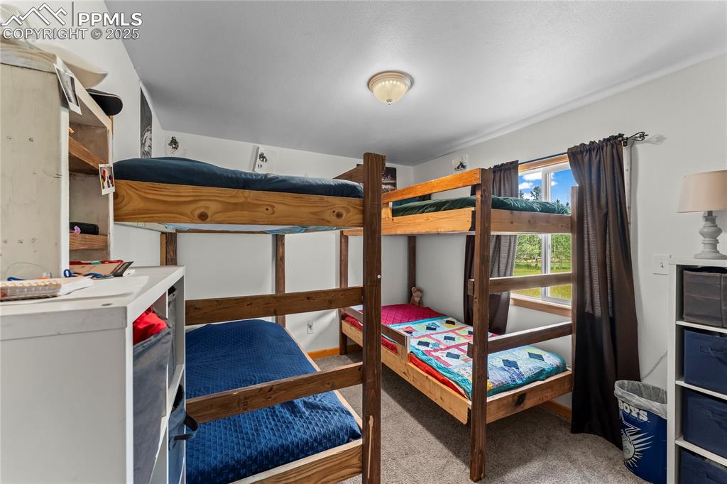 Bedroom featuring light colored carpet
