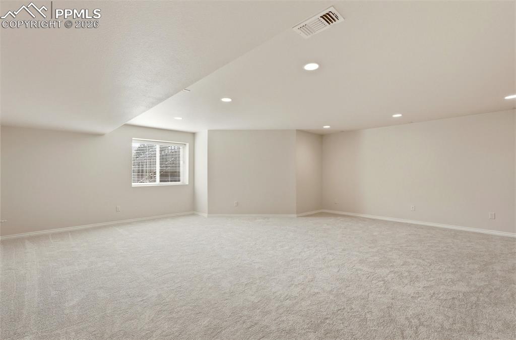 Below grade area featuring light carpet and recessed lighting