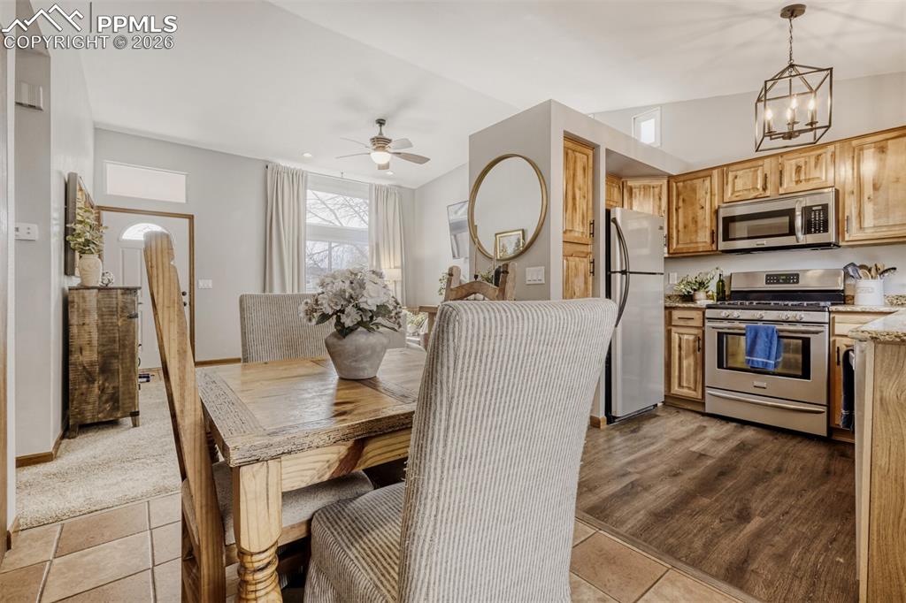 Dining area with ceiling fan and suspended lighting