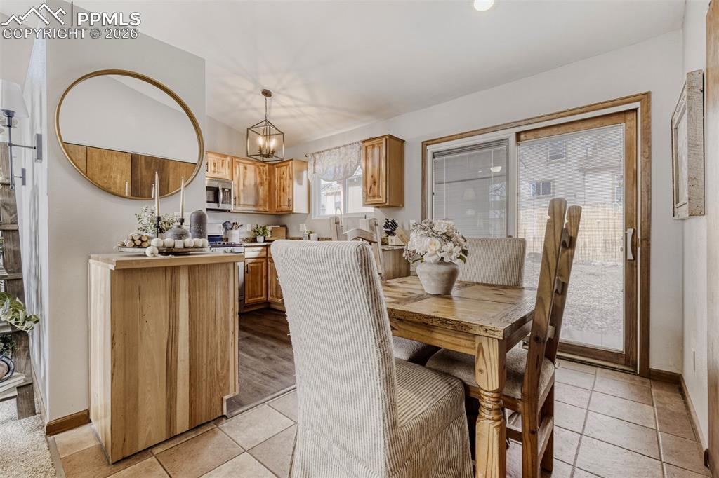 Dining room featuring a chandelier and light tile patterned floors