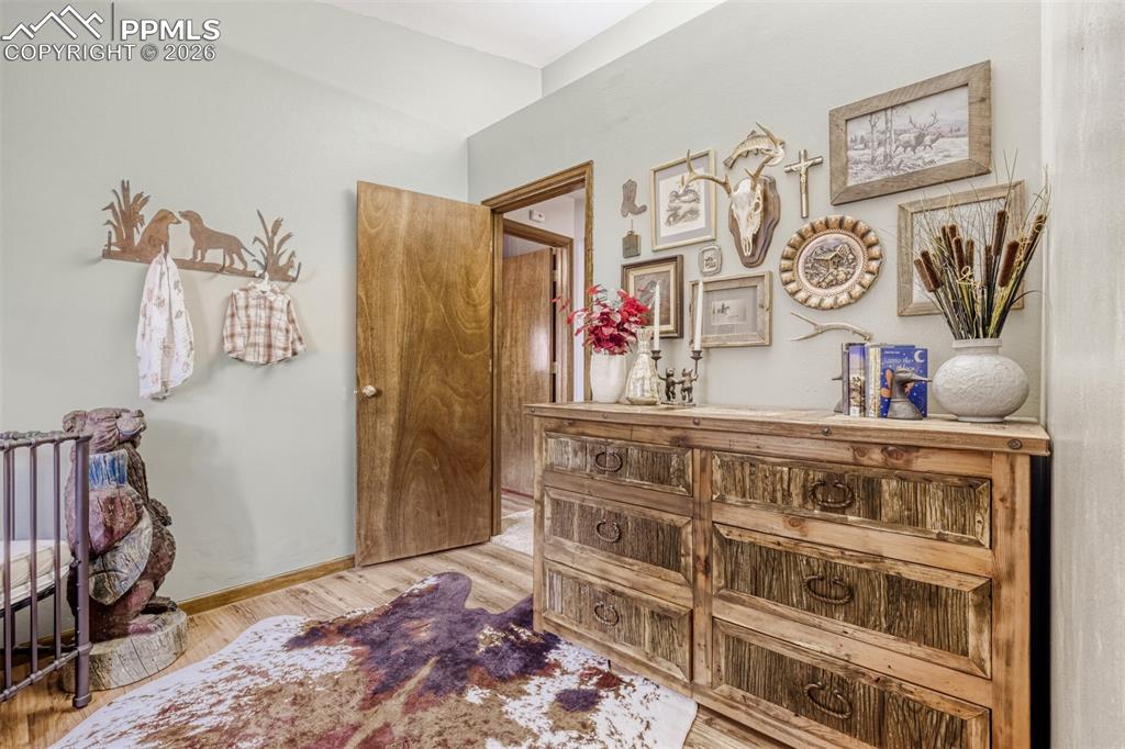 Hallway with light wood-style flooring and baseboards