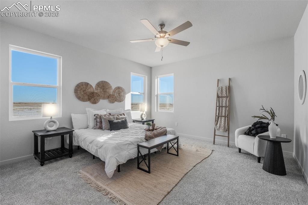 Bedroom featuring light carpet and a ceiling fan