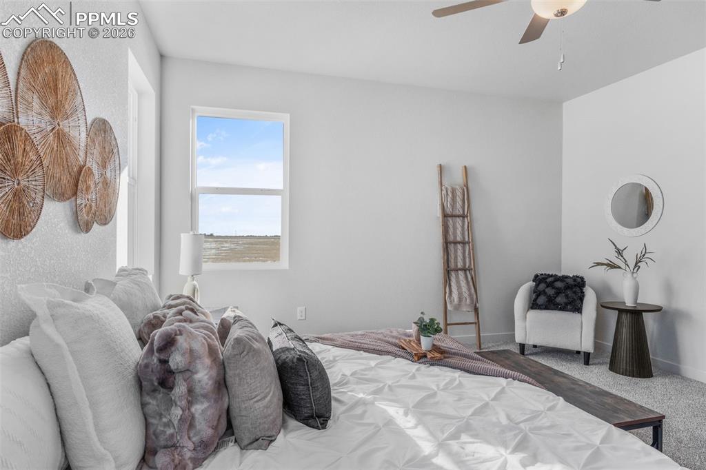 Bedroom featuring ceiling fan and carpet floors