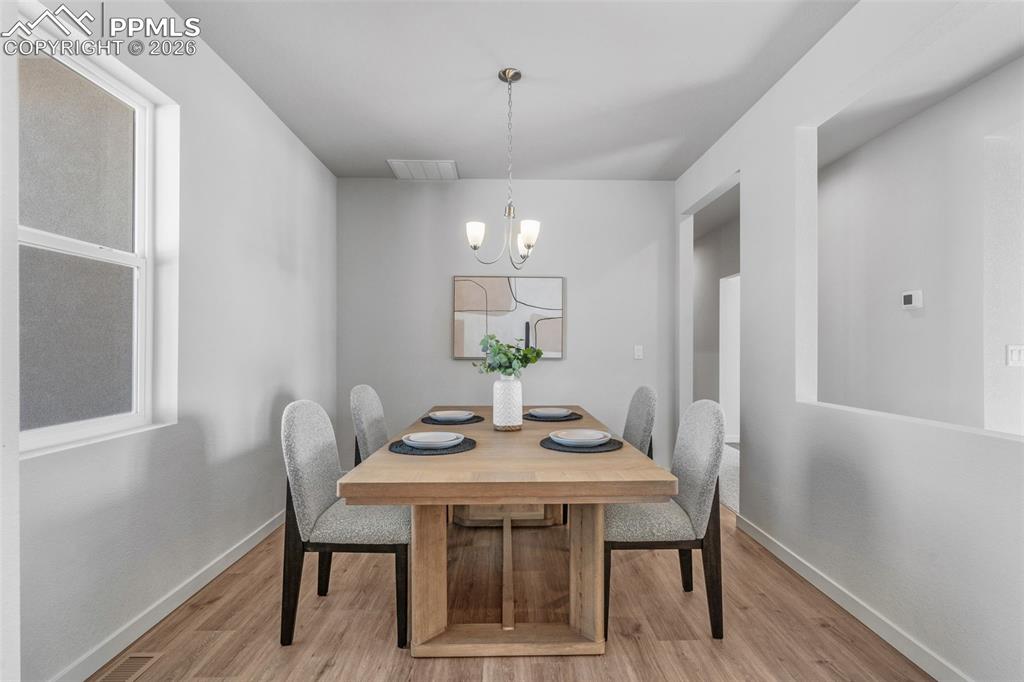 Dining space with a chandelier and light wood-style floors