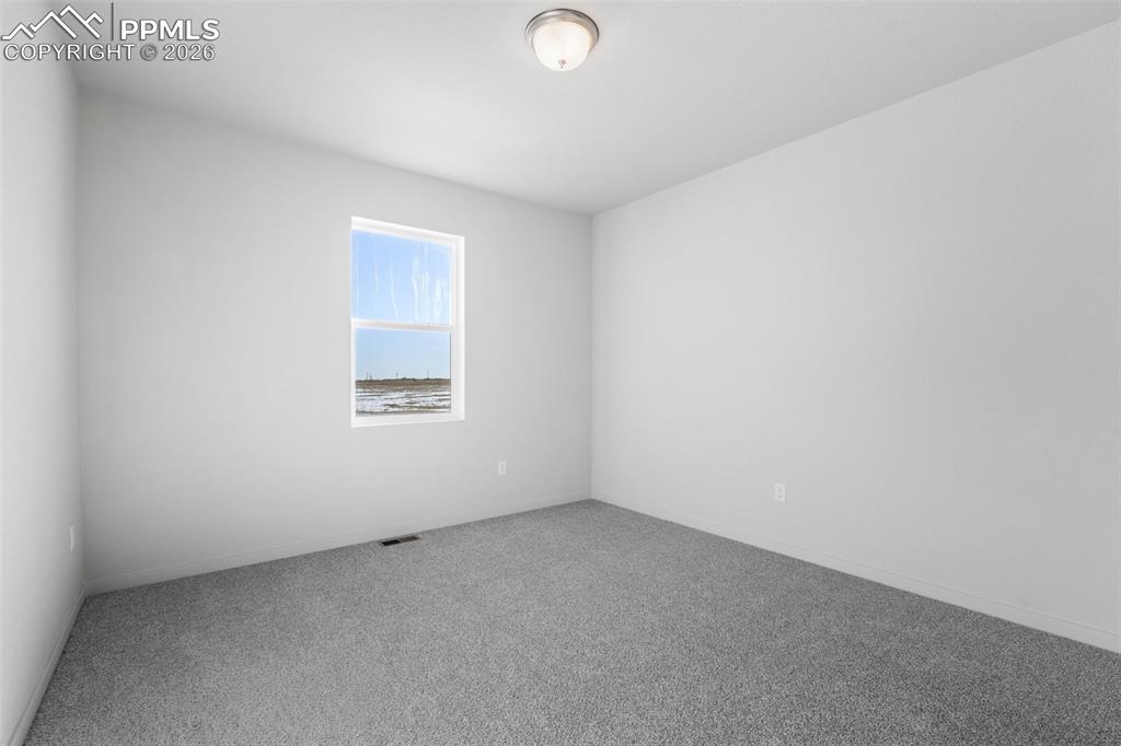 Spare room with carpet floors and baseboards