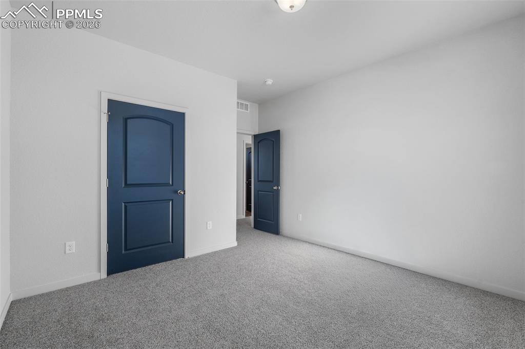 Unfurnished bedroom featuring carpet flooring and baseboards