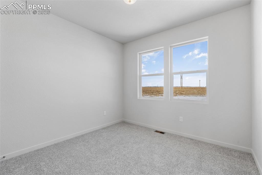 Spare room with carpet flooring and baseboards