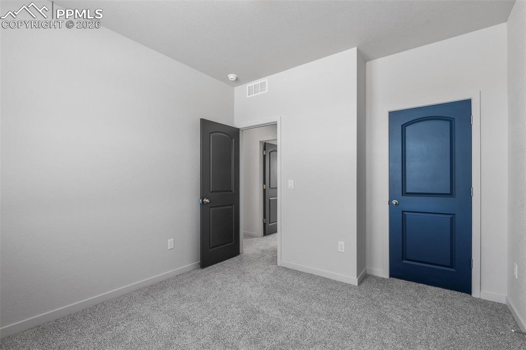 Unfurnished bedroom with carpet and baseboards