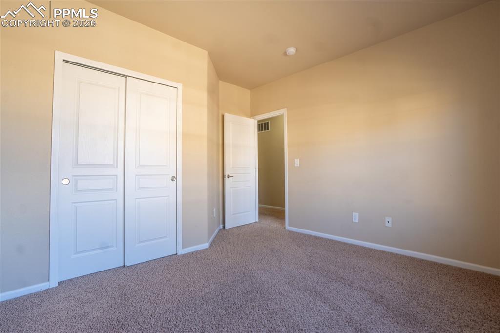 Unfurnished bedroom with carpet floors and a closet