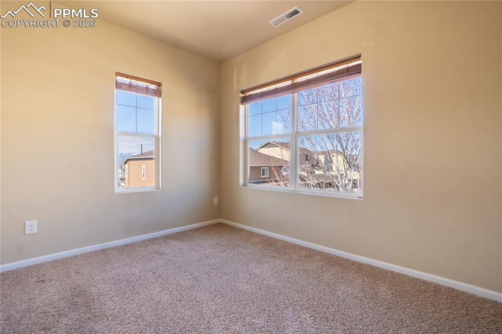 Unfurnished room featuring carpet floors and baseboards
